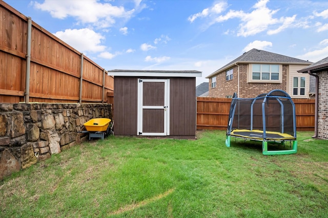 view of yard with a storage unit and a trampoline