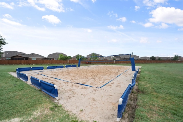 view of property's community featuring a yard and volleyball court