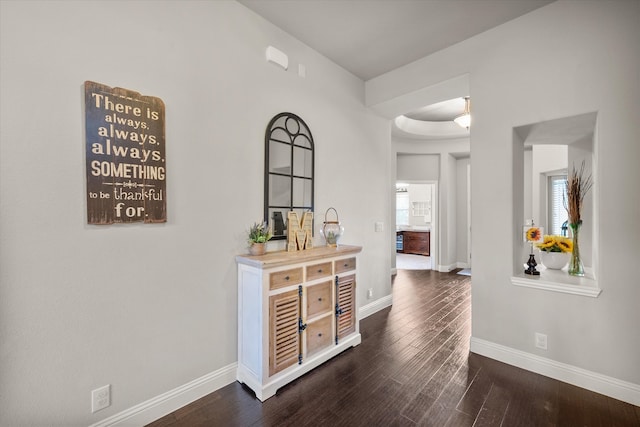 corridor with dark hardwood / wood-style floors