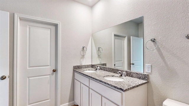 bathroom featuring toilet and vanity