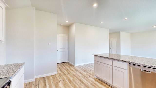 kitchen featuring appliances with stainless steel finishes, light hardwood / wood-style flooring, light stone counters, and white cabinetry