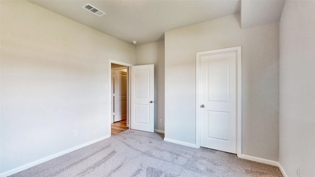 unfurnished bedroom featuring light colored carpet