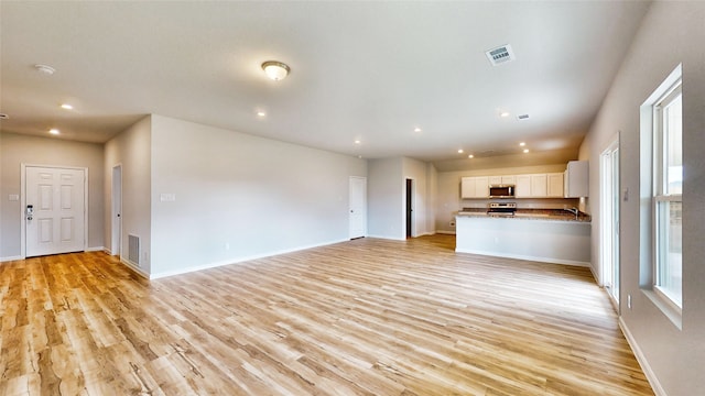 unfurnished living room featuring light wood-type flooring