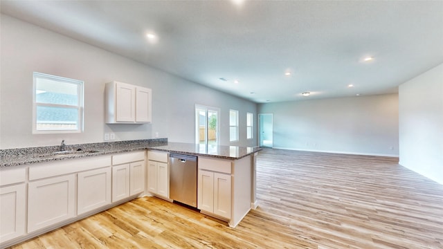 kitchen with stainless steel dishwasher, sink, light hardwood / wood-style floors, kitchen peninsula, and white cabinetry