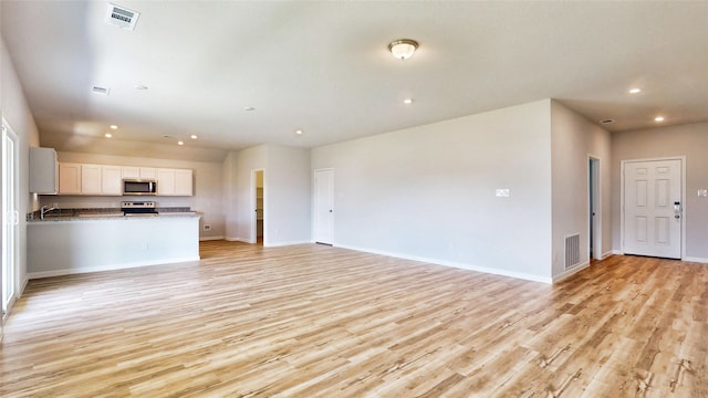 unfurnished living room featuring light wood-type flooring