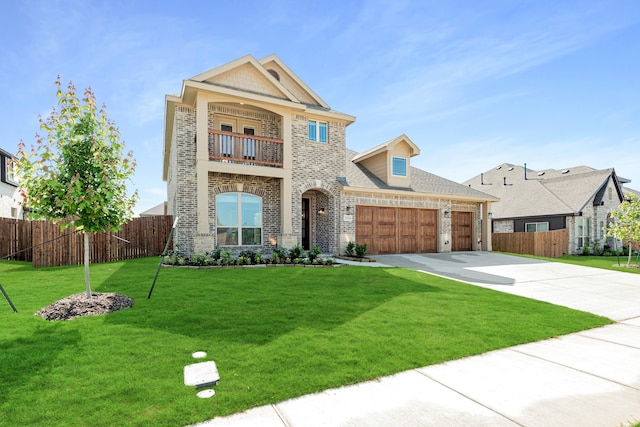 view of front of house with a front yard, a garage, and a balcony