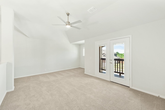 additional living space featuring lofted ceiling, french doors, visible vents, and light colored carpet