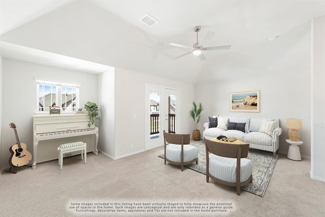 carpeted living area with lofted ceiling, visible vents, ceiling fan, and baseboards