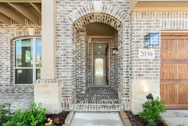 doorway to property with brick siding