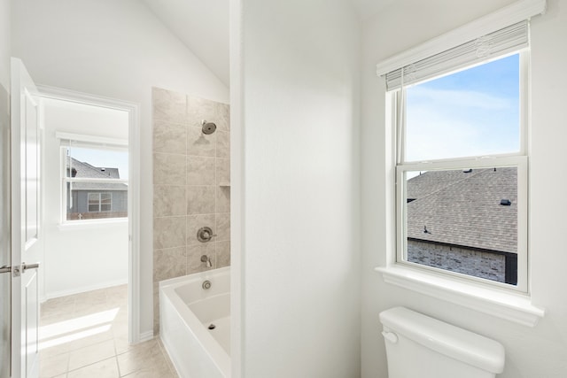 full bathroom with washtub / shower combination, tile patterned flooring, toilet, and lofted ceiling