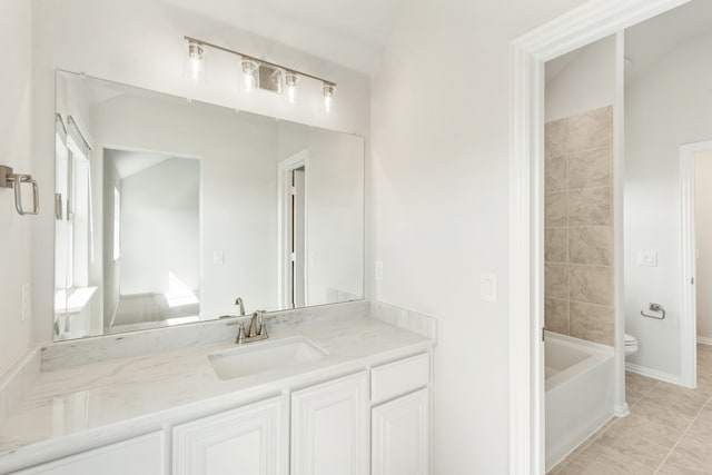 bathroom featuring toilet, a bathing tub, vanity, tile patterned flooring, and baseboards