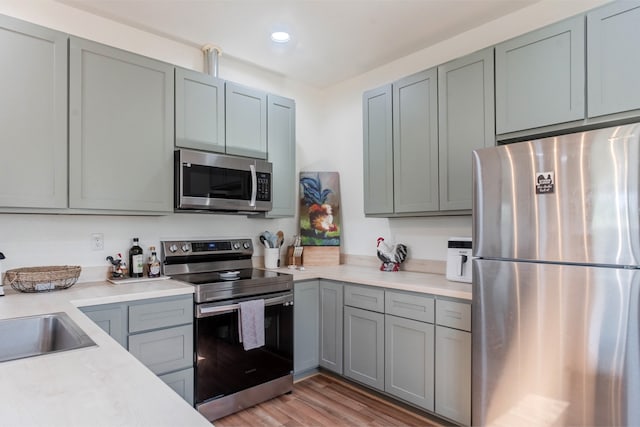 kitchen featuring sink, light hardwood / wood-style flooring, and stainless steel appliances