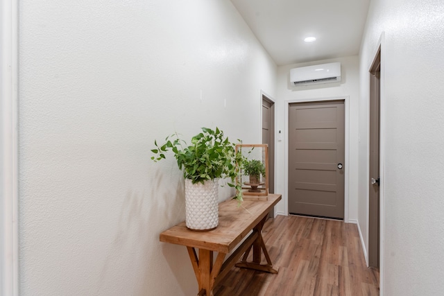 entryway with an AC wall unit and hardwood / wood-style flooring