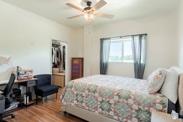 bedroom featuring ceiling fan, a closet, and hardwood / wood-style flooring