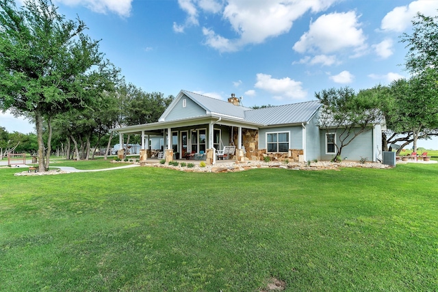 farmhouse-style home featuring a front yard, central AC, and covered porch