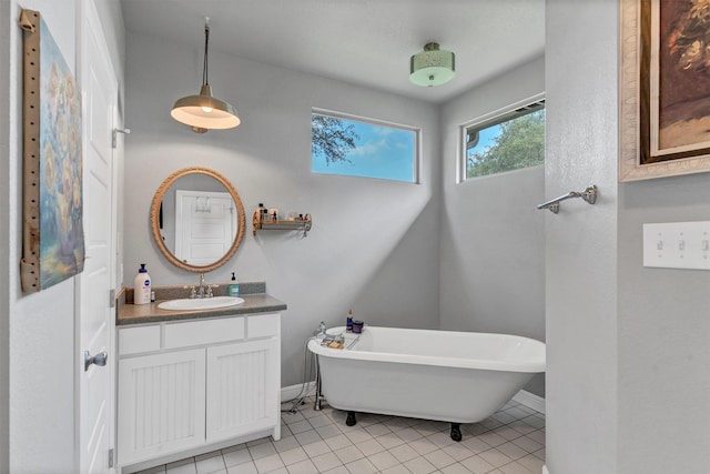 bathroom featuring a bathtub, tile floors, and large vanity