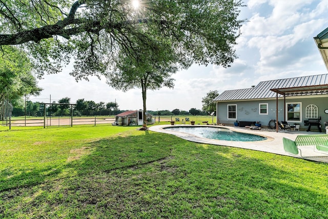 view of yard with a fenced in pool and a patio