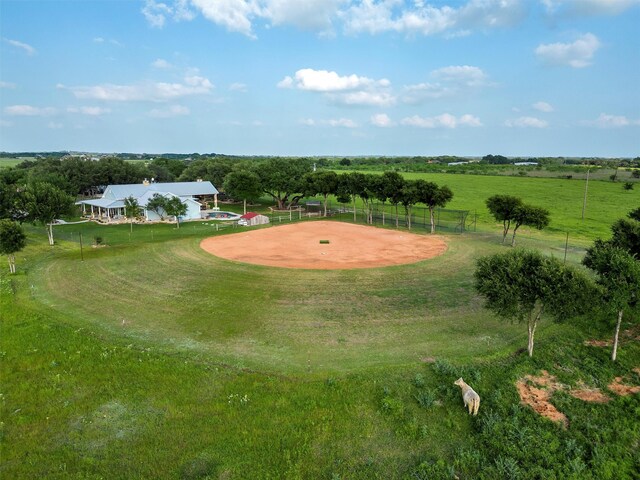 view of home's community featuring a rural view and a lawn