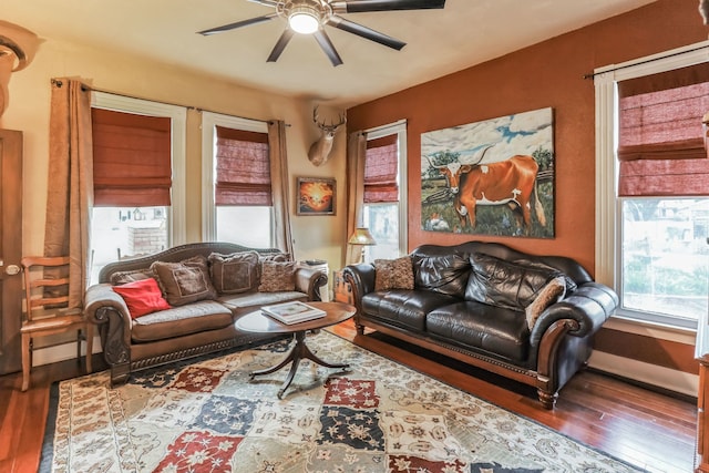 living room featuring ceiling fan and hardwood / wood-style floors