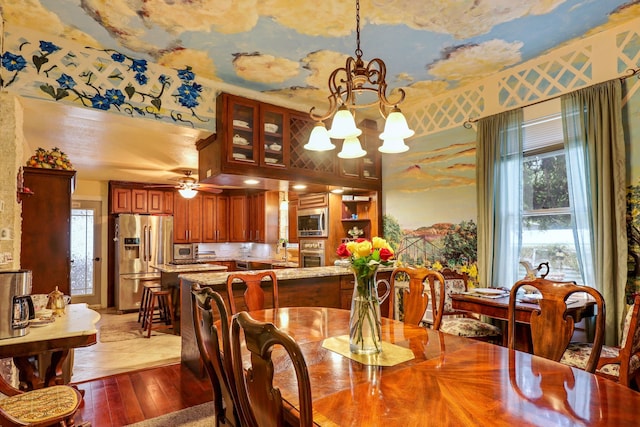 dining room featuring ceiling fan with notable chandelier and light tile floors