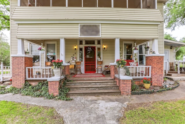 view of exterior entry with covered porch