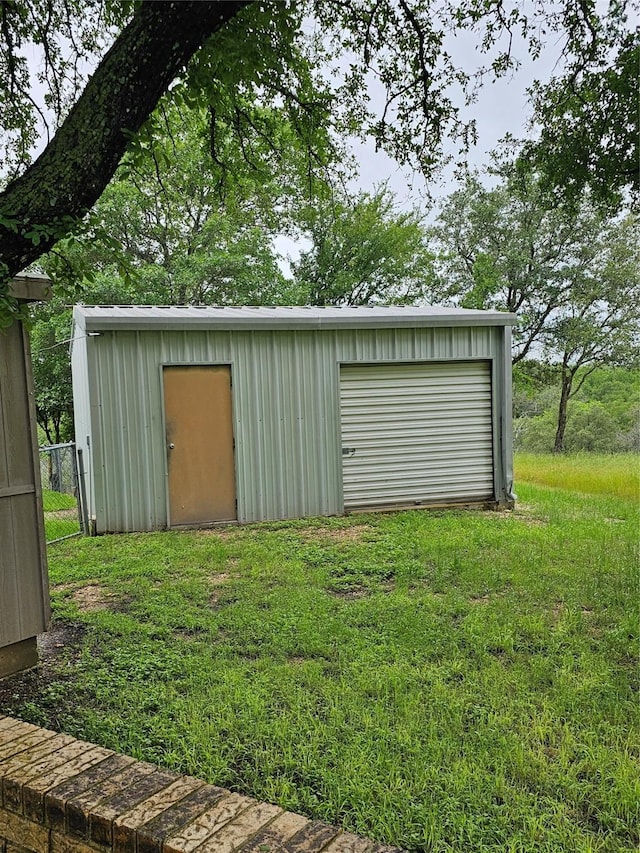 view of outbuilding featuring driveway and an outdoor structure