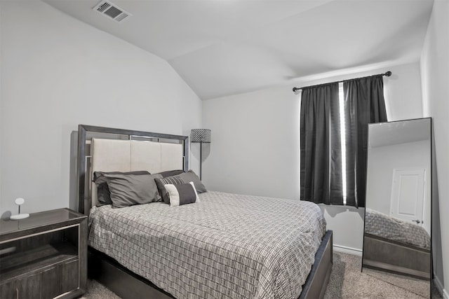 carpeted bedroom with lofted ceiling