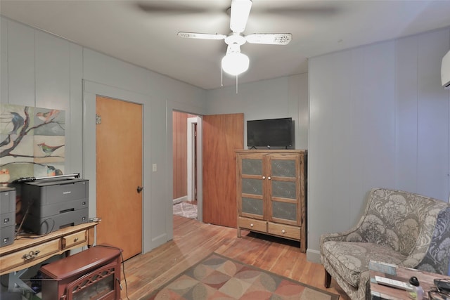 living area featuring ceiling fan and light hardwood / wood-style flooring