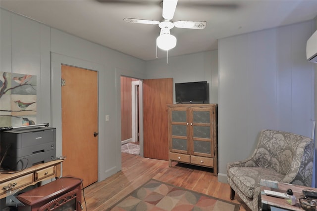 living area featuring ceiling fan and light hardwood / wood-style floors