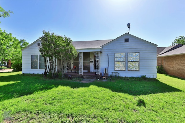 ranch-style home with covered porch and a front lawn