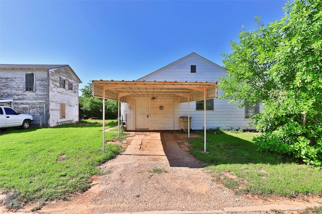 exterior space featuring a carport and a lawn