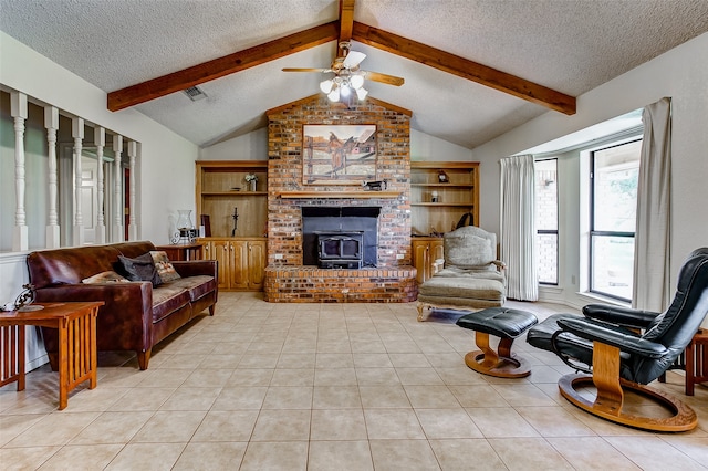 living room featuring ceiling fan, lofted ceiling with beams, a textured ceiling, and a brick fireplace