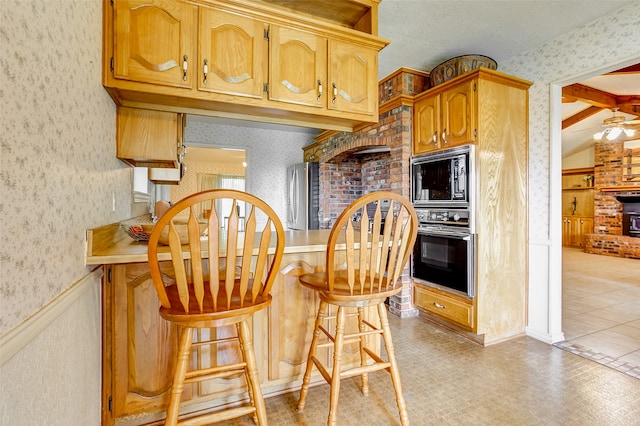 kitchen featuring a textured ceiling, lofted ceiling with beams, black appliances, light tile flooring, and ceiling fan