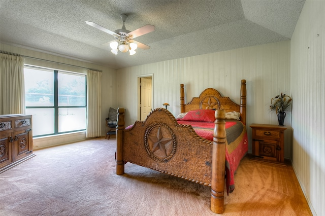 carpeted bedroom featuring a textured ceiling, ceiling fan, and vaulted ceiling