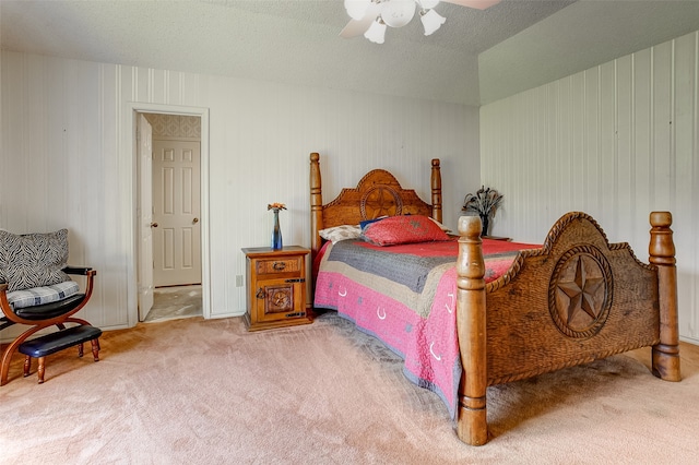 bedroom with ceiling fan, a textured ceiling, and carpet flooring