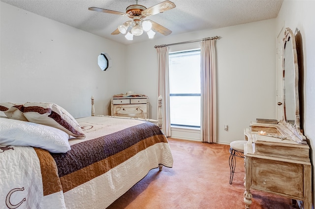 bedroom with ceiling fan, a textured ceiling, and carpet flooring