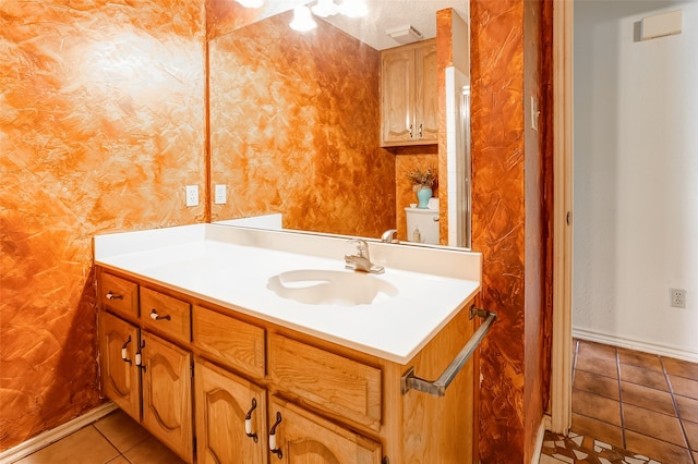 bathroom featuring tile floors, a textured ceiling, and vanity