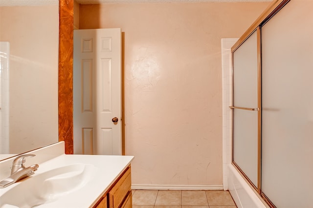 bathroom with tile floors, shower / bath combination with glass door, and vanity with extensive cabinet space