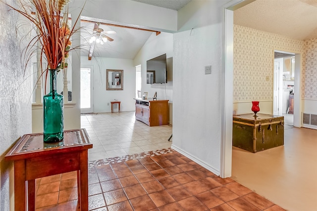 foyer entrance featuring lofted ceiling with beams, ceiling fan, and tile floors