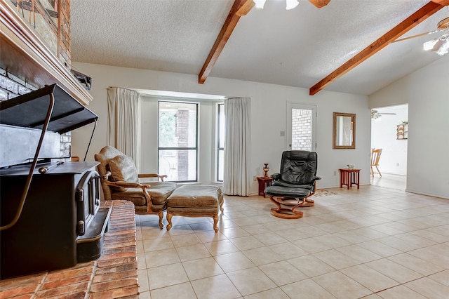 living room featuring a textured ceiling, lofted ceiling with beams, ceiling fan, and light tile floors