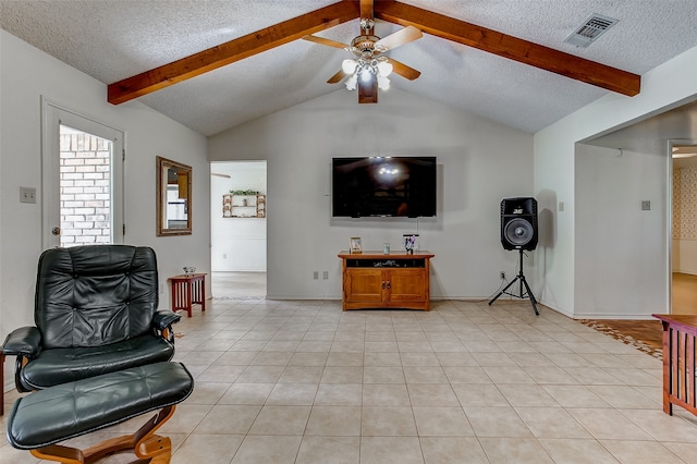 tiled living room with a textured ceiling, lofted ceiling with beams, and ceiling fan