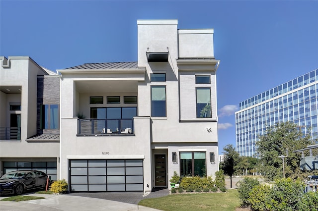 view of front of house featuring a garage and a balcony