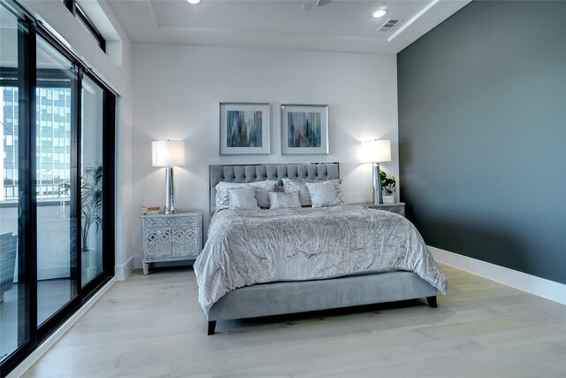 bedroom with ceiling fan, light wood-type flooring, and access to exterior