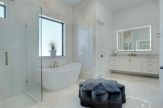 bathroom featuring tile flooring, tile walls, and large vanity