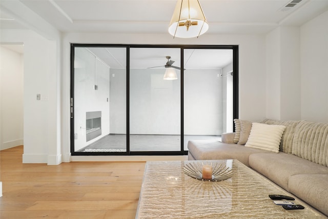 living room featuring wood-type flooring and ceiling fan