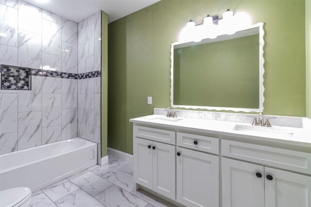 full bathroom with oversized vanity, toilet, tiled shower / bath combo, tile floors, and dual sinks