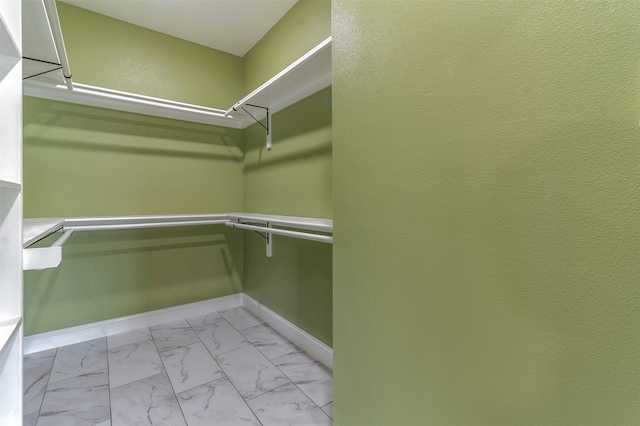 spacious closet with light tile flooring