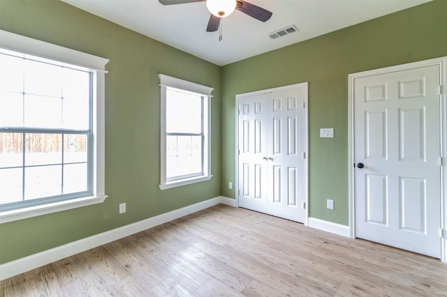 unfurnished bedroom with ceiling fan and light wood-type flooring