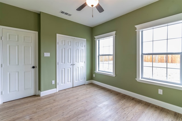 unfurnished bedroom with a closet, ceiling fan, and light wood-type flooring