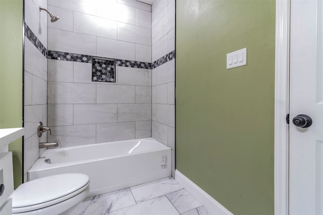 full bathroom with tile floors, vanity, tiled shower / bath combo, and toilet